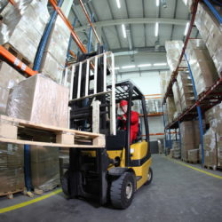 forklift operator at work in warehouse